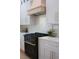 Close-up of a modern stove with light wood cabinets in a kitchen at 13393 Sw 484 Hwy, Ocala, FL 34481