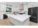Modern kitchen featuring a large island, stainless steel appliances, and custom cabinetry at 13393 Sw 484 Hwy, Ocala, FL 34481