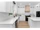 Modern kitchen featuring white cabinets, stainless steel appliances, and breakfast bar at 13393 Sw 484 Hwy, Ocala, FL 34481