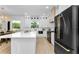 Modern kitchen featuring a large island, stainless steel appliances, and custom cabinetry at 13393 Sw 484 Hwy, Ocala, FL 34481