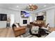 Bright living room with fireplace, television, leather furniture, hard wood floors, and modern decor at 13393 Sw 484 Hwy, Ocala, FL 34481