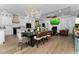 Open living area with fireplace, television, modern decor, and wood flooring at 13393 Sw 484 Hwy, Ocala, FL 34481