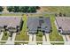 Aerial view of two-story townhomes with garages and solar panels at 1396 Mirabella Cir, Davenport, FL 33897