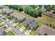 An aerial view shows the gray and brown townhomes with well-manicured lawns on a sunny day at 1396 Mirabella Cir, Davenport, FL 33897