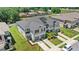 Aerial view of modern townhomes, showcasing spacious driveways and lush landscaping at 1396 Mirabella Cir, Davenport, FL 33897