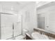 Clean bathroom featuring a glass-enclosed shower, granite vanity, and a bright, well-lit mirror at 1396 Mirabella Cir, Davenport, FL 33897
