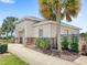 Exterior of a single-story building with brick accents, landscaping, and a palm tree at 1396 Mirabella Cir, Davenport, FL 33897