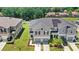 The exterior shows a two-story gray townhome with a two-car garage, solar panels, and well-kept landscaping at 1396 Mirabella Cir, Davenport, FL 33897