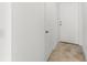 Hallway showcasing tile flooring, white doors, and plenty of natural light at 1396 Mirabella Cir, Davenport, FL 33897