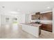 Bright kitchen features stainless steel appliances, granite countertops, and central island with sink at 1396 Mirabella Cir, Davenport, FL 33897