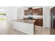 Bright kitchen features stainless steel appliances, granite countertops, and central island with sink at 1396 Mirabella Cir, Davenport, FL 33897