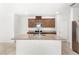 Bright kitchen features stainless steel appliances, granite countertops, and central island with sink at 1396 Mirabella Cir, Davenport, FL 33897