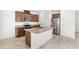 Bright kitchen features stainless steel appliances, granite countertops, and central island with sink at 1396 Mirabella Cir, Davenport, FL 33897