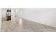 Open-concept living space with tile flooring flowing into a kitchen featuring a central island at 1396 Mirabella Cir, Davenport, FL 33897