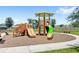 Community playground with slides, climbing structures, and seating areas, ideal for  at 1396 Mirabella Cir, Davenport, FL 33897