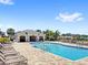 Beautiful community pool with lounge chairs and covered seating area, perfect for relaxation at 1396 Mirabella Cir, Davenport, FL 33897