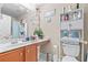 Cozy bathroom featuring a white toilet, cabinet storage, and decorated mirror at 14 Sequoia Way, Kissimmee, FL 34758