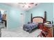 Bright bedroom with blue walls, white tile flooring, and standard closet and bathroom door at 14 Sequoia Way, Kissimmee, FL 34758