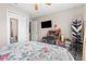 Neutral bedroom featuring a tv, closet, and computer desk at 14 Sequoia Way, Kissimmee, FL 34758