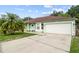 Beautiful, single-story home with well maintained lawn and a wide driveway leading to a two-car garage at 14 Sequoia Way, Kissimmee, FL 34758