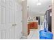 A view into the Kitchen offering ample storage and countertop space, complemented by white tiled flooring at 14 Sequoia Way, Kissimmee, FL 34758