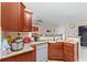 Traditional kitchen with granite countertops and wood cabinetry, complemented by modern appliances at 14 Sequoia Way, Kissimmee, FL 34758