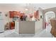 Open-concept kitchen with granite countertops, tile flooring, wooden cabinetry, and views into adjacent dining area at 14 Sequoia Way, Kissimmee, FL 34758