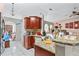 Open kitchen featuring granite counters, white cabinets, arched doorways and a combined area with dining and living spaces at 14 Sequoia Way, Kissimmee, FL 34758