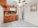 Compact kitchenette with wood cabinets and a microwave oven at 14 Sequoia Way, Kissimmee, FL 34758
