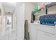 Functional laundry room with a washing machine and dryer, plus extra storage space on shelving at 14 Sequoia Way, Kissimmee, FL 34758