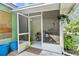 View of the screened porch leading to backyard featuring plants and room for storage at 14 Sequoia Way, Kissimmee, FL 34758