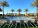 Community pool with seating and palm trees at 1438 Ridgeback Ln, Apopka, FL 32703