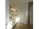 Bright bathroom featuring white cabinetry, double sinks and a nautical theme throughout the space at 14955 Lebeau Loop, Winter Garden, FL 34787