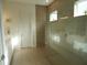 Modern bathroom featuring a glass walk-in shower, neutral tiling, and white cabinetry at 14955 Lebeau Loop, Winter Garden, FL 34787