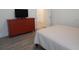 Bedroom with dresser and view into hallway at 14955 Lebeau Loop, Winter Garden, FL 34787