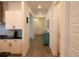 Bright hallway with modern flooring, leading past the kitchen to the home's entrance for easy access at 14955 Lebeau Loop, Winter Garden, FL 34787