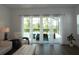Bright living room featuring sliding glass doors that open to a screened-in pool area, blending indoor and outdoor living at 14955 Lebeau Loop, Winter Garden, FL 34787