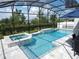 Stunning screened-in pool area with a spa, offering a luxurious and private outdoor retreat for relaxation and recreation at 14955 Lebeau Loop, Winter Garden, FL 34787