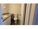 Neutral-colored bathroom with toilet, sink, and vanity at 1504 Virginia Ave # 105, Daytona Beach, FL 32114