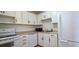 Cozy kitchen features white appliances, cabinets, and laminate countertops at 1504 Virginia Ave # 105, Daytona Beach, FL 32114