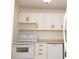 Cozy kitchen features white appliances, cabinets, and laminate countertops at 1504 Virginia Ave # 105, Daytona Beach, FL 32114