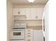 Cozy kitchen features white appliances, cabinets, and laminate countertops at 1504 Virginia Ave # 105, Daytona Beach, FL 32114