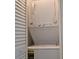 A stacked white GE laundry unit is conveniently located behind shuttered closet doors at 1504 Virginia Ave # 105, Daytona Beach, FL 32114