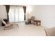 Bright living room with tile floors and large windows with light filtering curtains at 1504 Virginia Ave # 105, Daytona Beach, FL 32114