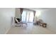 Bright living room with tile floors and large windows with light filtering curtains at 1504 Virginia Ave # 105, Daytona Beach, FL 32114