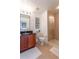 Cozy bathroom featuring a tiled shower, dark granite counters, and cherry-stained vanity cabinet at 1521 Chatfield Pl, Orlando, FL 32814