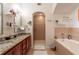 Luxurious bathroom features double sinks, granite countertops, soaking tub, and tiled shower for ultimate relaxation at 1521 Chatfield Pl, Orlando, FL 32814
