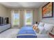Bright bedroom with large windows, modern decor, and comfortable furnishings for a relaxing living space at 1521 Chatfield Pl, Orlando, FL 32814