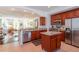 Updated kitchen featuring granite countertops, stainless steel appliances, cherry cabinets, and center island at 1521 Chatfield Pl, Orlando, FL 32814
