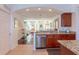 Spacious kitchen with granite countertops flows into the bright and inviting living area with stairs at 1521 Chatfield Pl, Orlando, FL 32814
